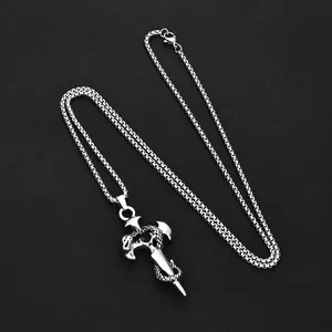 Detailed view of silver snake sword cross pendant with black gem on chunky chain link