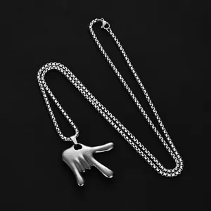 Hip-hop rock hand gesture pendant on silver box chain against a black background