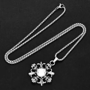 Detail of gothic silver skull pendant with clear crystal on a square box chain