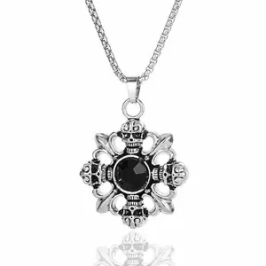 Macro detail of gothic skull pendant with black gemstone and silver cross engraving