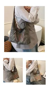 Detail view of large vintage canvas shoulder bag with leather handles and studded W letter