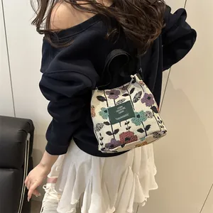 Floral knit tote bag with colorful flower patterns and green woven handle for women