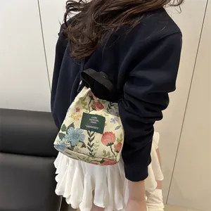 Floral jacquard tote bag with blue and pink flowers and black shoulder straps