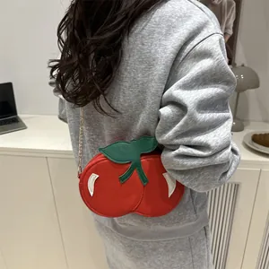 Creative red cherry shaped crossbody bag with green leaf detail and gold chain strap