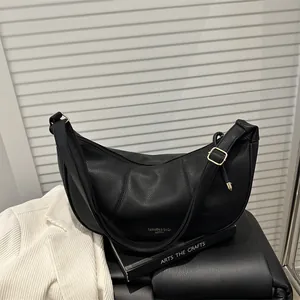 Large black crescent hobo bag in lychee pattern leather with golden zipper and strap