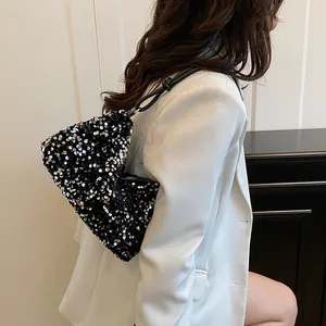 Chic silver sequin shoulder bag for women with black leather strap on a model
