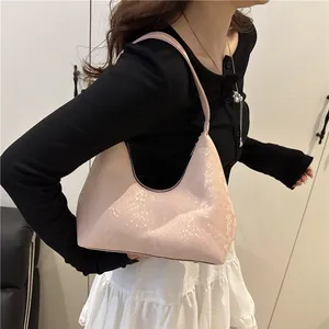 Pink croc-embossed hobo bag with a minimalist half-moon silhouette for daily fashion