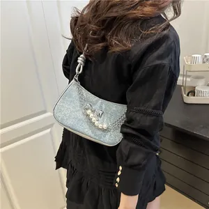 Light blue denim shoulder bag with silver butterfly charm and pearl chain decoration