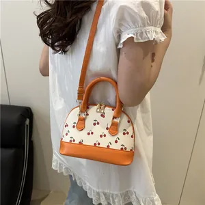Mini cherry print shell handbag with bright orange strap and handles for women