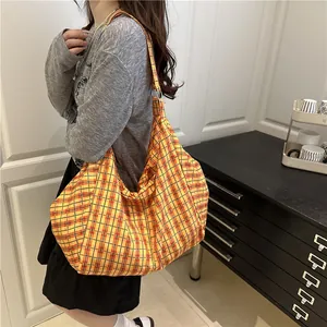 Large yellow and red checkered canvas shoulder bag with a casual slouchy design