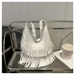 Detail van witte halve maan tas met boho franjes en textuur van kunstlederen materiaal