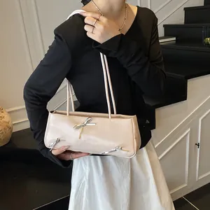 Elegant cream rectangular shoulder bag with silver bow details for chic urban styling