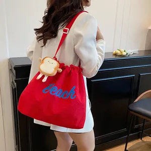 Lightweight bright red canvas drawstring tote bag with Beach print and toast pendant