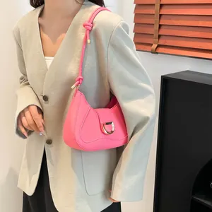 Hot pink faux leather hobo bag with gold D-ring buckle and knotted shoulder strap