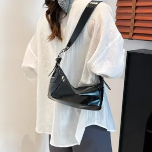 Large black glossy patent leather shoulder bag for women with silver metal hardware