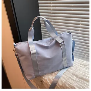 Macro detail of high-capacity oxford travel bag with adjustable strap and light blue finish