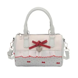 Blue and cream underarm bag with red bow and heart pendant in Boston style for women
