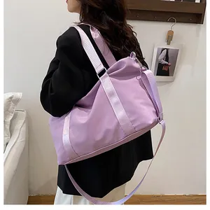 Detail view of purple large capacity travel bag with nylon fabric and metal clips