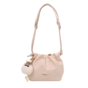 Chic cream pink pleated bucket bag with adjustable strap and cute plush charm detail