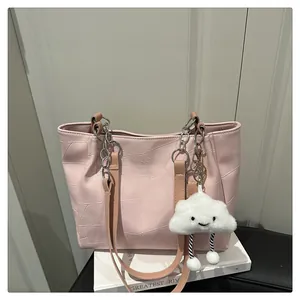 Detail of light pink tote bag with geometric stitching and plush cloud charm