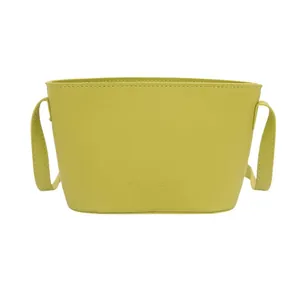 Minimalist avocado green bucket bag with FANYISSA embossed logo on textured leather surface
