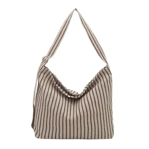 Minimalist large canvas tote bag with black stripes and adjustable shoulder strap