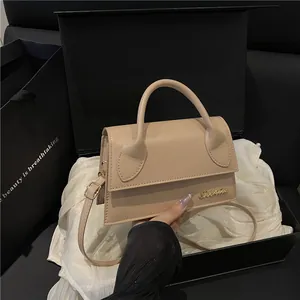 Elegant beige leather crossbody flap bag with gold logo on white silk and gift box
