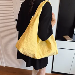 Bright yellow large capacity nylon tote bag with wide strap for casual summer commuting