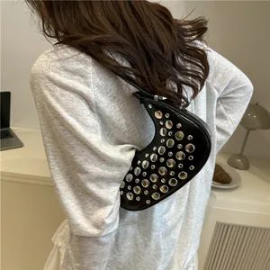 Chic black crescent underarm bag with silver metallic rivets and glossy leather finish