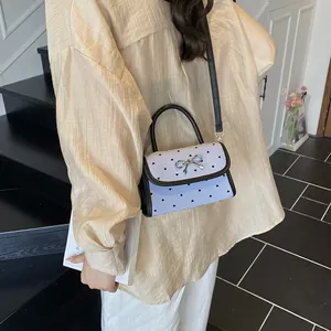 Light blue striped mini bag with black heart patterns and silver metal bow detail