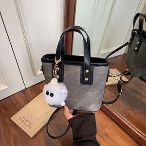 Retro grey denim handbag with black leather trim and cute monster plush pendant
