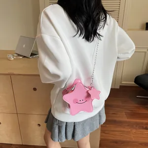Chic pink star-shaped crossbody bag with metal chain strap and smiley face print