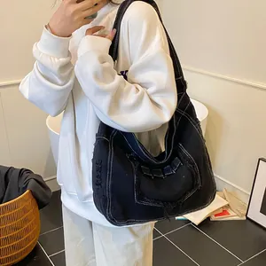 Japanese style black denim hobo bag with contrast stitching and distressed details