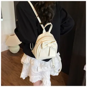 Rear view of model wearing a mini cream bow backpack for daily commuting and styling