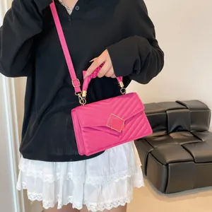 Magenta quilted crossbody bag with pleated handle and golden hardware for women