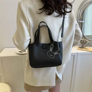 Classic black soft leather commuter tote bag with fashion bunny charm and shoulder strap