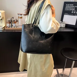 Vintage black embossed tote bag with elegant floral patterns for daily commute