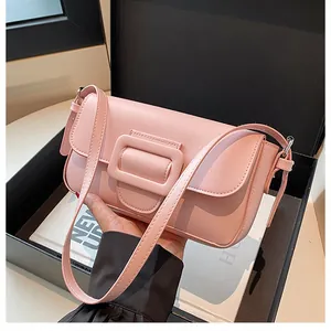 Detailed close-up of pink faux leather shoulder bag with a large matching buckle