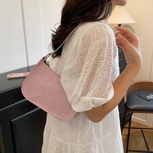 Pink rhinestone shoulder bag for women styled with a white lace dress for a trendy look