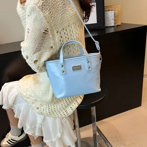 Elegant light blue leather bucket handbag with adjustable strap for women in summer
