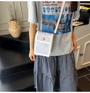 Close-up of New Chinese style crossbody phone bag with floral embroidery and gold clasp