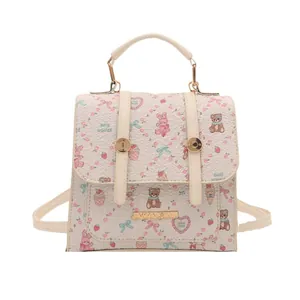 Minimalist beige crossbody backpack featuring cute cartoon prints and golden hardware