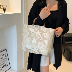 Floral jacquard tote bag with bamboo handles and elegant off-white embroidered texture
