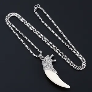 Punk wolf head pendant with resin tusk and silver box chain on black background