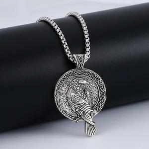 Silver Viking raven pendant necklace with Celtic knot pattern on a gray background