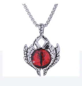 Macro detail of devil eye pendant with red dragon eye and cracked silver metal texture