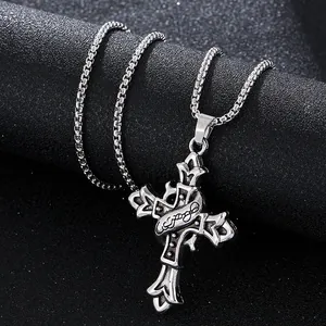 Retro silver cross necklace with floral engraving and box chain on black display