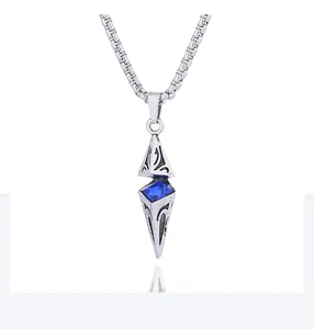 Macro shot of silver retro pendant with square blue gemstone and black engraved patterns
