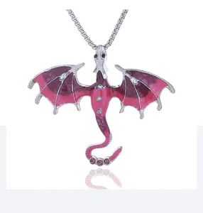 Detail of dragon pendant with pink-purple enamel and rhinestones on a silver chain