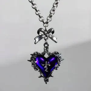 Gothic punk silver necklace with purple heart, silver cross, and metal bow detail